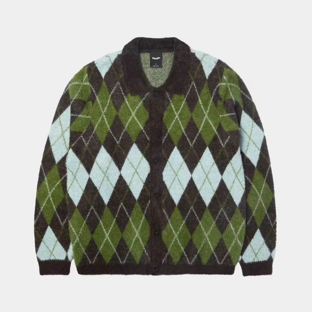Fuzzy brown, green, and pale blue argyle cardigan with a black collar, buttons, and ribbed cuffs on a gray background