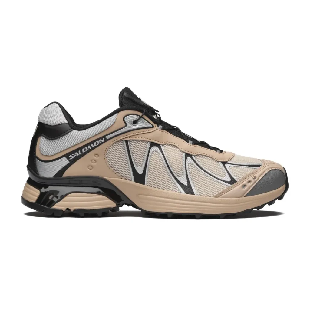 Beige and gray Salomon trail sneaker with black accents, mesh panels, laces, and rugged sole on white background