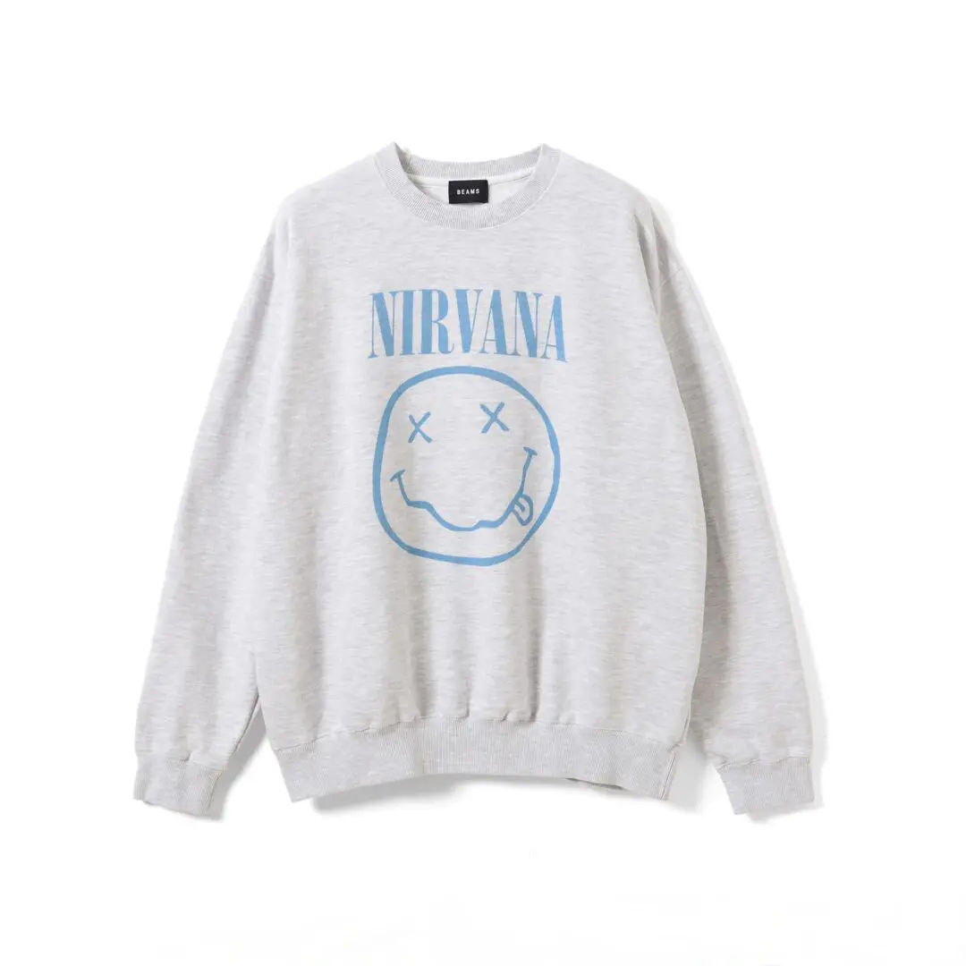 Light gray crewneck sweatshirt with blue Nirvana text and a distressed smiley-face graphic, isolated on white background