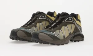 Pair of Salomon trail shoe in brown, black, gray, and yellow, positioned side by side on a white background