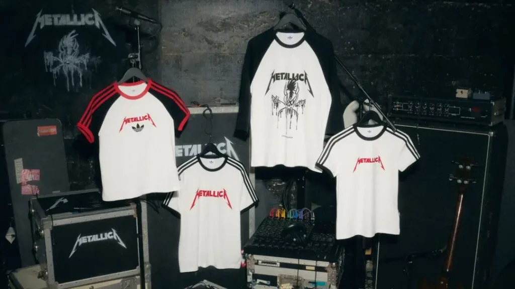 Four Metallica shirts hang in a dark studio among audio equipment and cases