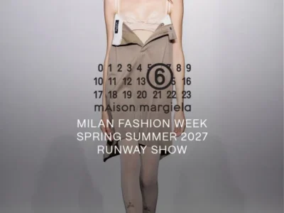 Model in dark sunglasses wears a beige camisole, asymmetrical folded skirt and sheer tights on a runway