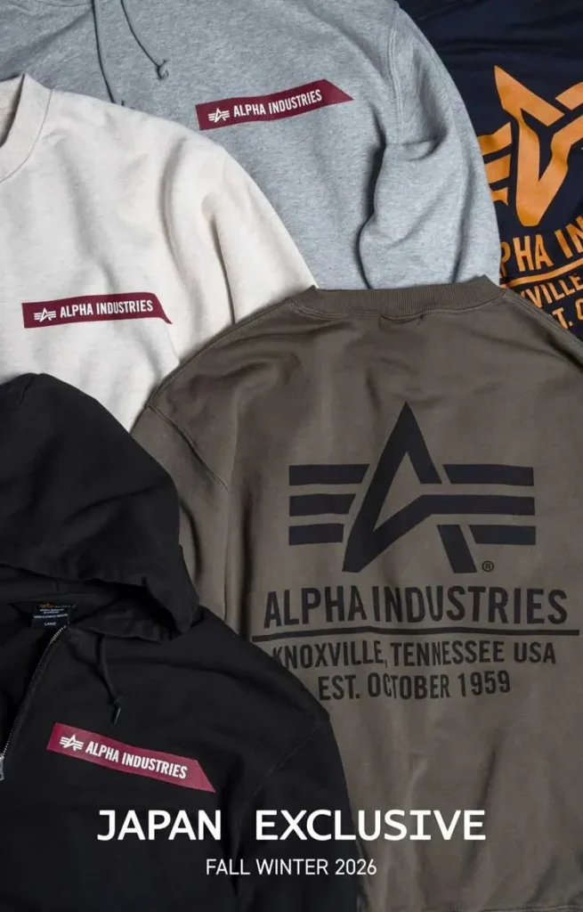 Alpha Industries sweatshirts and jacket arranged together, featuring maroon logo patches and large printed branding in gray