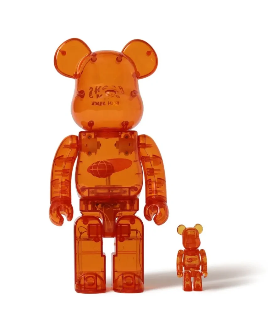 Large and small translucent orange bear-shaped figures standing side by side on a white background