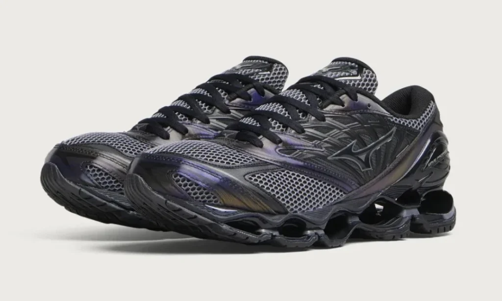 Pair of black and gray mesh shoe with thick sculpted soles, shown overlapping against a light gray background