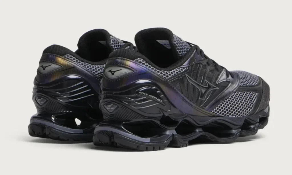 Pair of black Mizuno Wave Prophecy sneakers with metallic purple accents and mesh panels on a white background