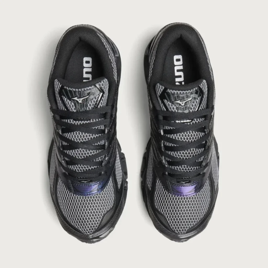Top-down view of black and gray mesh athletic shoe with black laces and purple accents on a white background