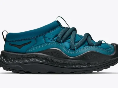Teal Hoka Ora Primo shoe with black laces, textured black midsole, and rugged outsole on a white background