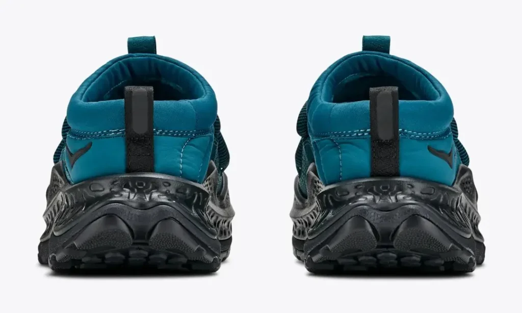Rear view of two teal and black Hoka Ora Primo shoes with padded collars, pull tabs, and rugged textured soles on white