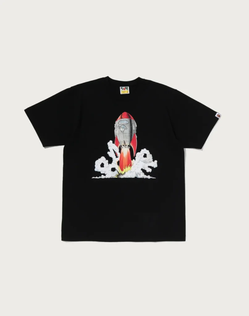 Black T-shirt with a colorful rocket launching through white clouds, displayed flat against a light background