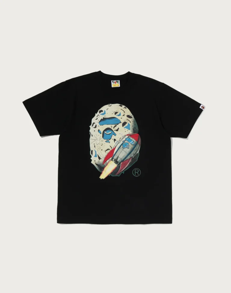 Black Tee laid flat on a pale background, with an illustrated moon and red-and-blue rocket graphic on the chest