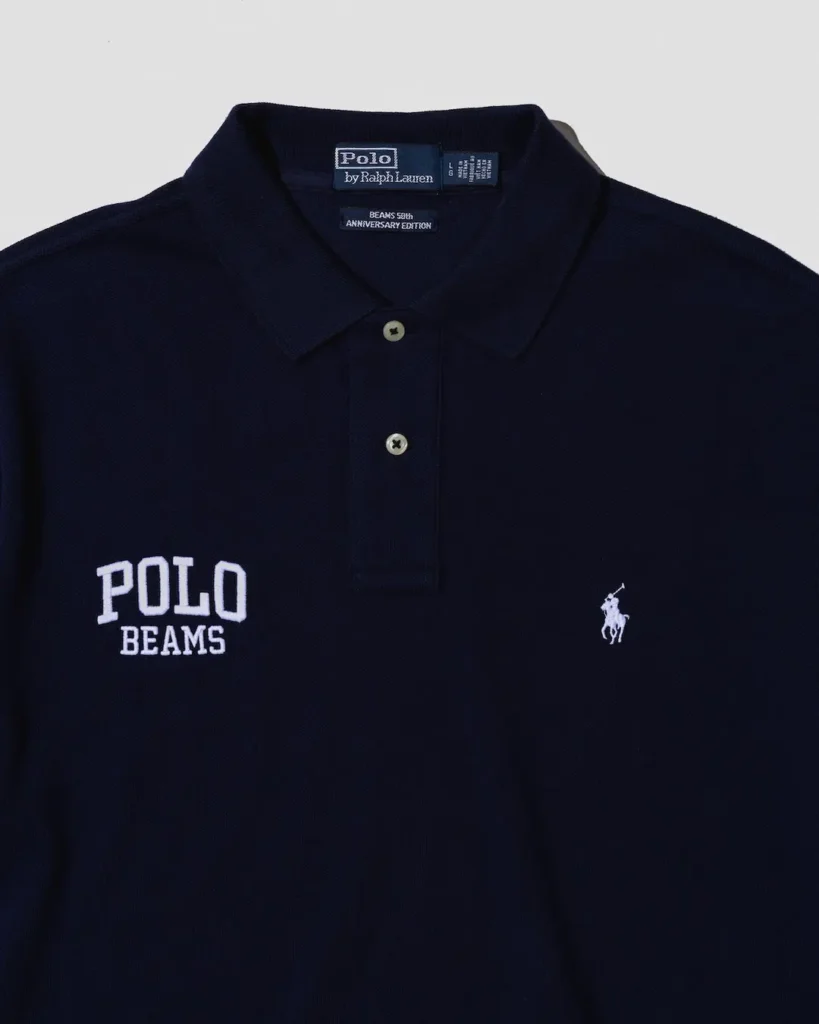 Navy Polo by Ralph Lauren shirt with white “POLO BEAMS” text and horse logo, shown against a light background