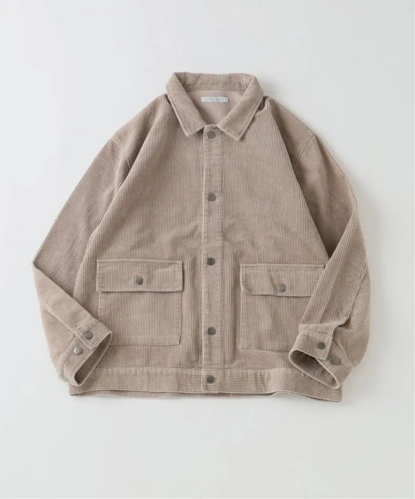 Beige corduroy jacket laid flat, with pointed collar, button front, and two flap pockets on a white background
