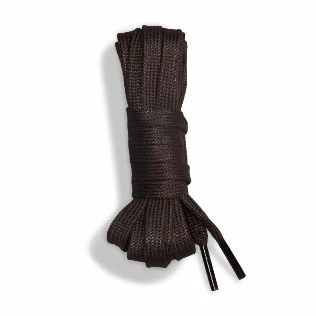 Dark brown knitted necktie with a wide ribbed knot and loose ends, photographed against a white background