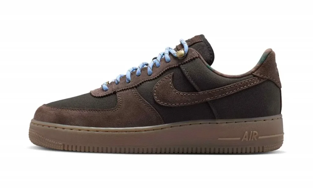 Side profile of a brown Nike Air Force 1 sneaker with blue laces and a matching brown sole on a white background