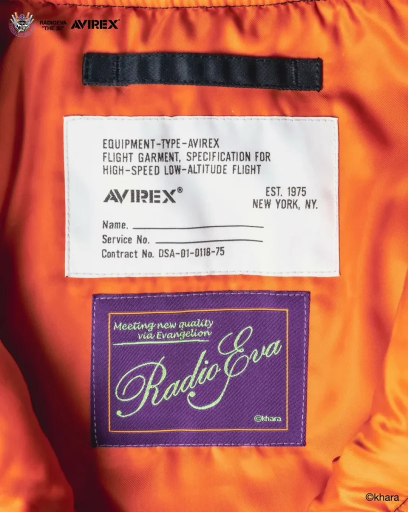 Close-up of orange MA-1 jacket lining with black strap and white AVIREX flight garment label above a purple Radio Eva patch