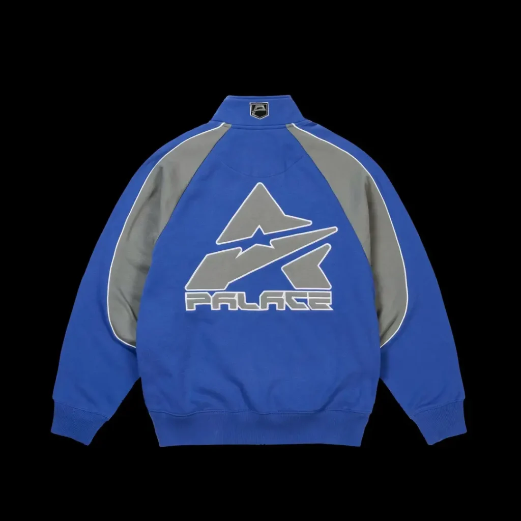 Blue and gray zip-up jacket with white piping and a large stylized logo, displayed against a black background