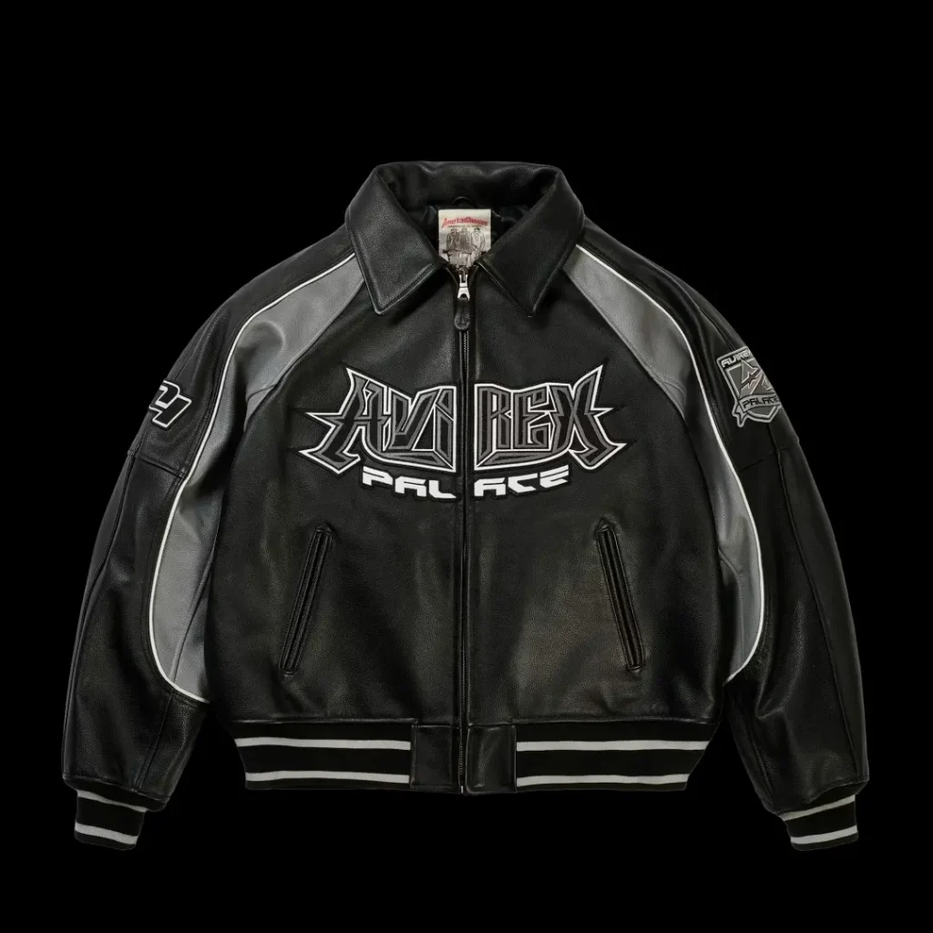 Black leather zip-up jacket with gray panels, striped cuffs and hem, and large white AMBUSH-style chest lettering on black