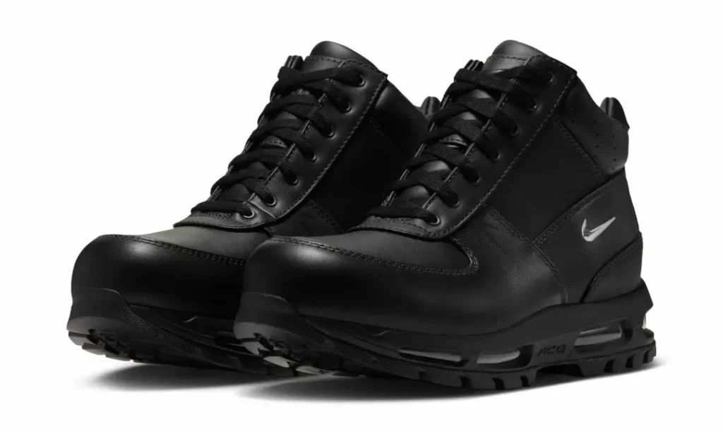 Pair of black Nike high-top sneakers with laces, swoosh logos, and rugged lugged soles on a white background