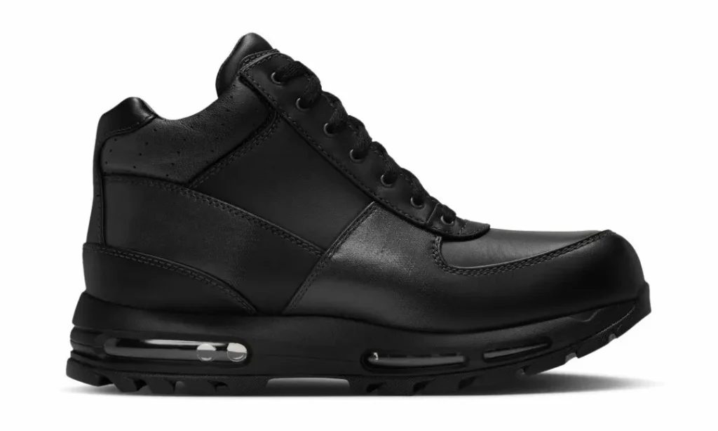 Black leather high-top sneaker with laces, stitched panels, and a visible air-cushioned sole on a white background