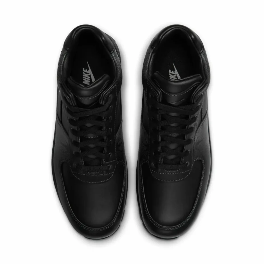 Pair of black Nike leather shoe shown from above on a white background