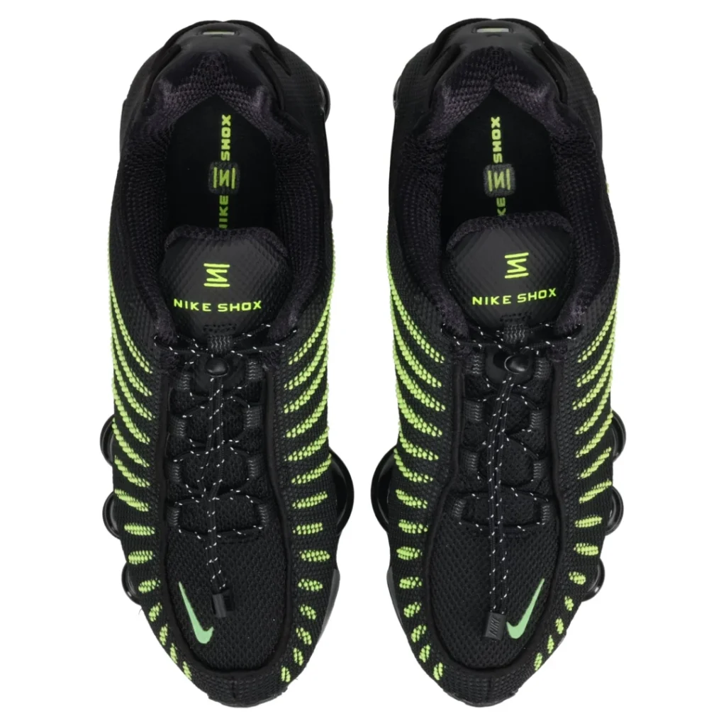 Pair of black Nike Shox shoe with neon green accents, shown from above against a white background