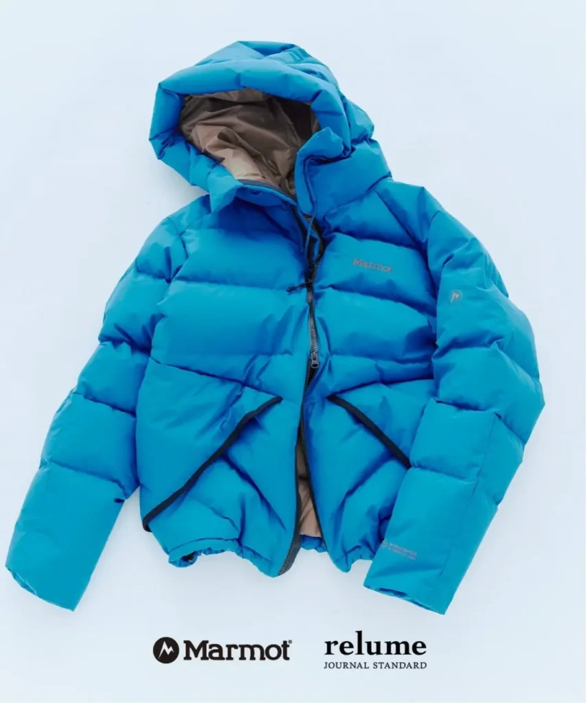 Bright blue Marmot hooded puffer jacket displayed flat on a pale background, with logos beneath