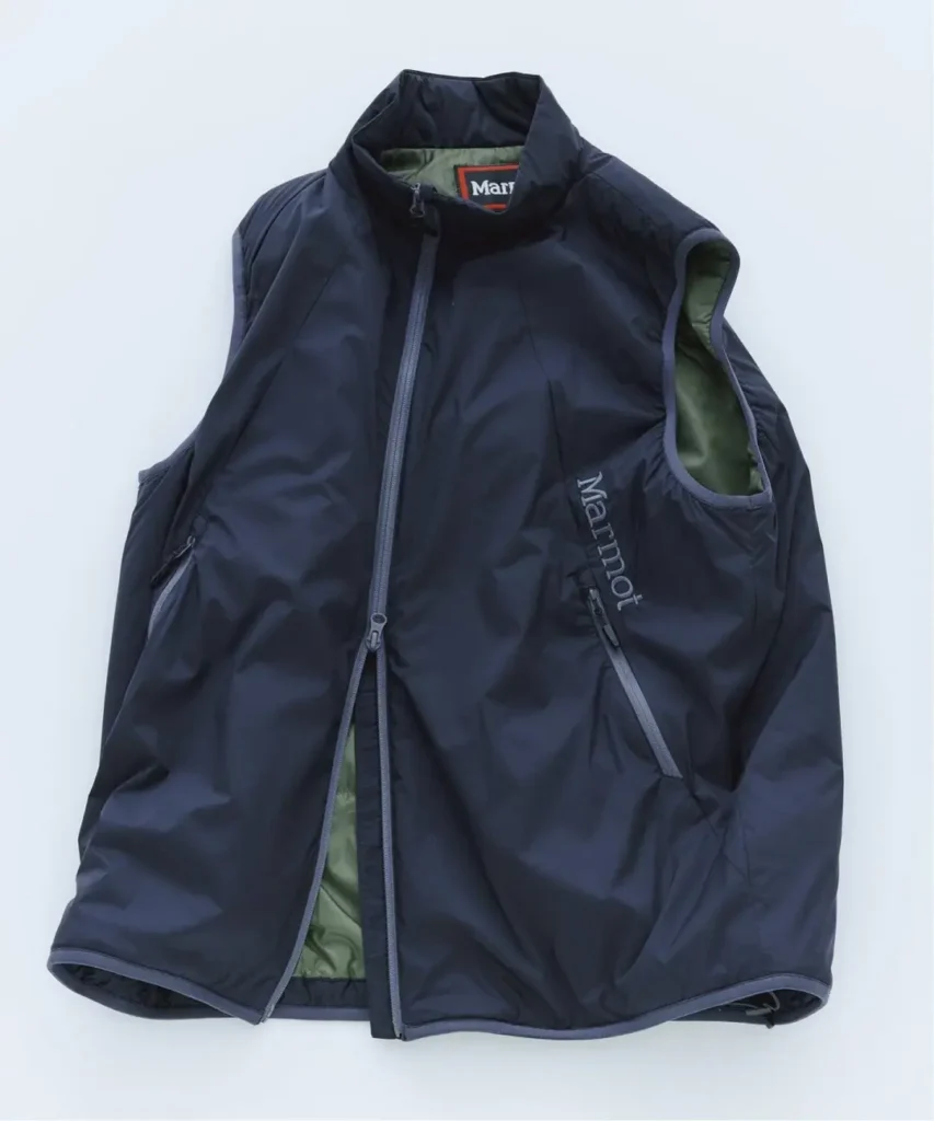 Navy Marmot zip-front vest with green lining, high collar and zippered pockets, laid flat on a pale background