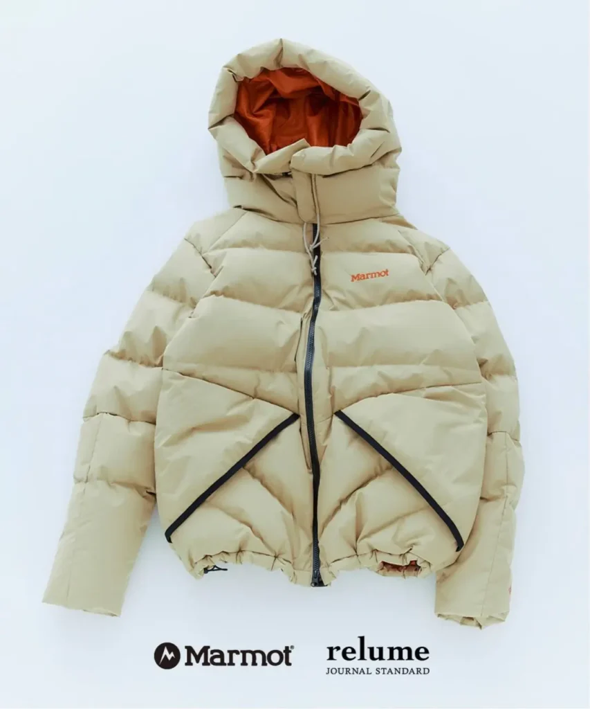 Beige hooded puffer jacket with orange lining, black zipper details, and Marmot and relume logos on a white background