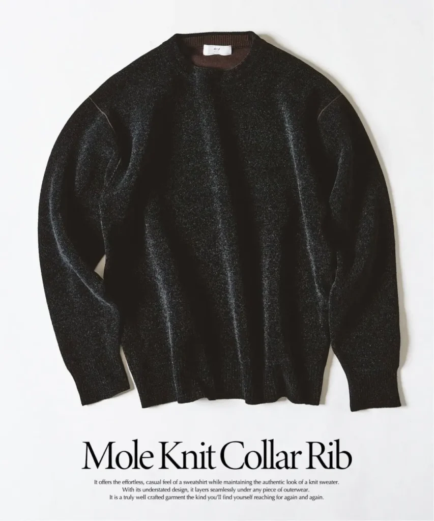 Black long-sleeved crewneck knit sweater laid flat on a white background, with ribbed collar, cuffs and hem