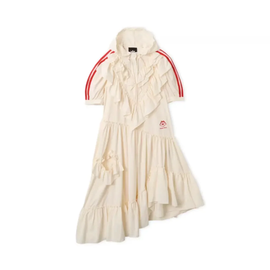 Cream ruffled dress with hood, red sleeve stripes, tiered skirt, and small red chest logo on a white background