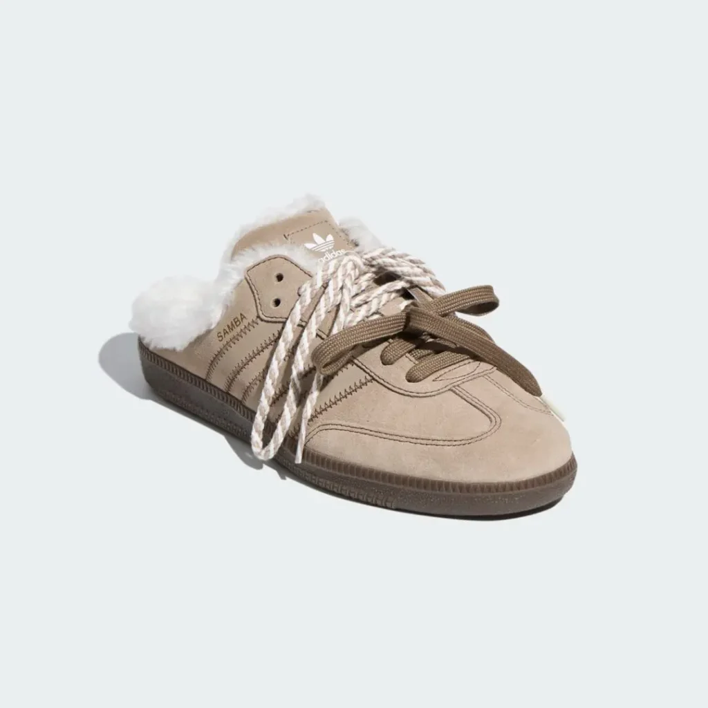 Tan Adidas Samba sneaker with white fleece lining and oversized brown-and-white rope laces on a pale background