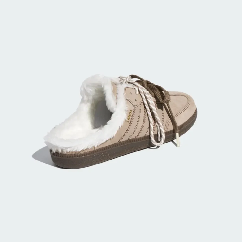 Cream lace-up shoe with white faux-fur lining, brown sole and laces, shown against a pale background