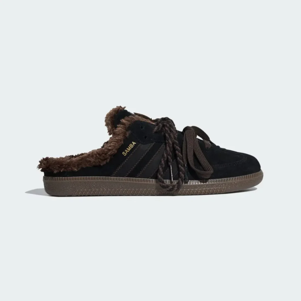 Black low-top shoe with brown shearling lining, braided laces, gum sole, and “SAMBA” lettering on a pale background