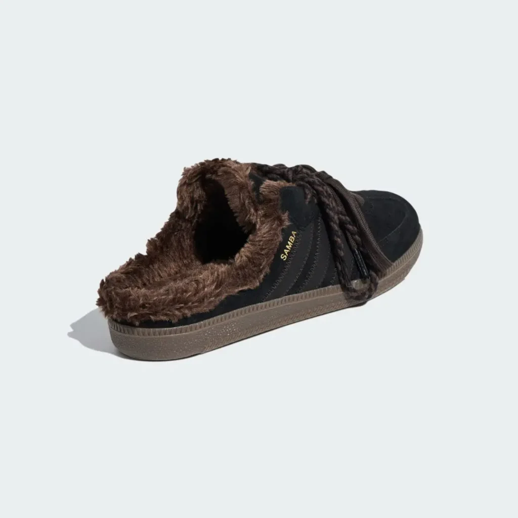 Black SAMBA sneaker with brown faux-fur lining and gum sole, isolated on a pale background