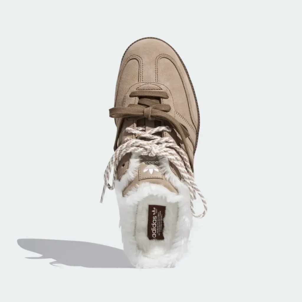 Tan Adidas sneaker with oversized braided laces and white furry lining, viewed from above against a pale background