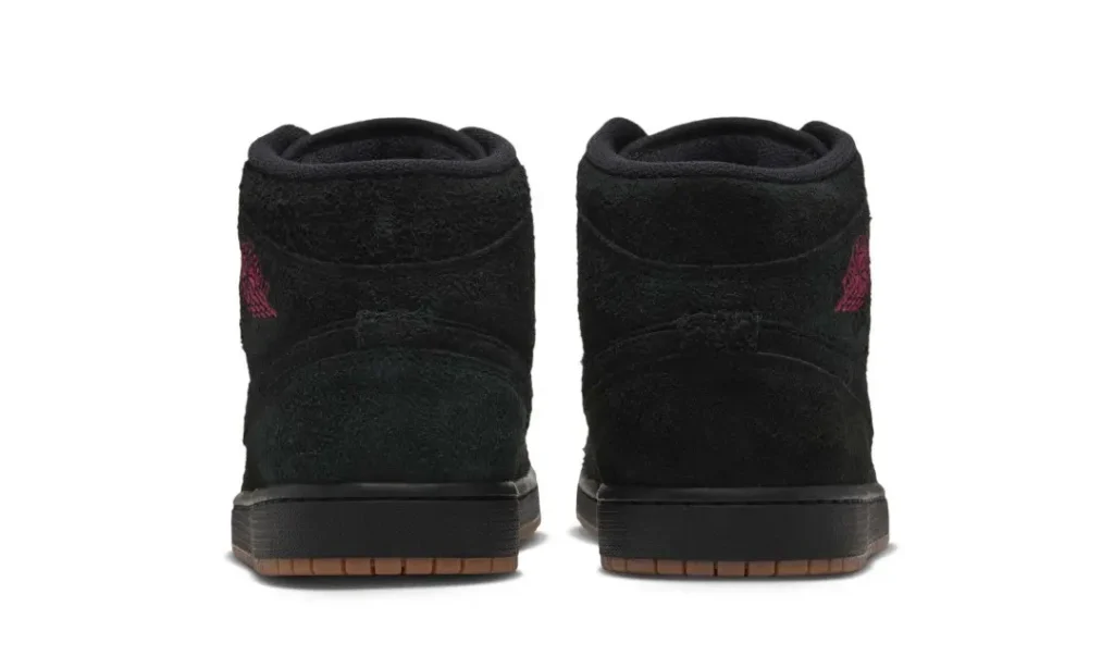 Pair of black high-top shoe shown from the rear, with red side logos and gum-tint outsoles on a white background