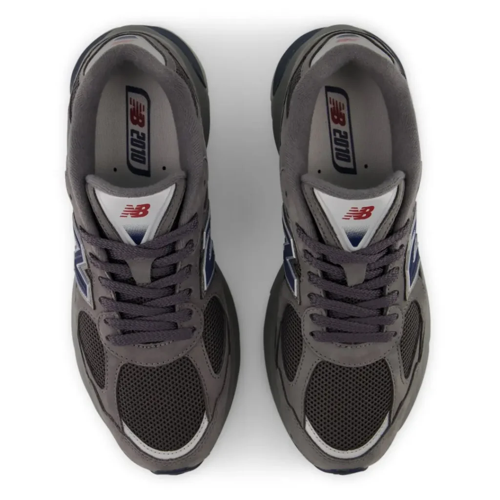 Pair of gray New Balance 2000 sneakers with dark mesh panels and laces, viewed from above on a white background