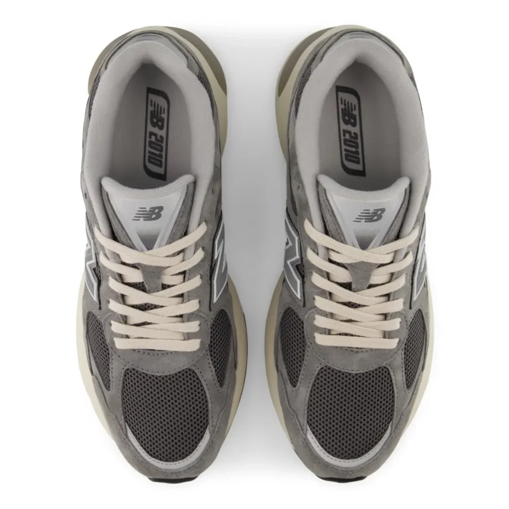Top view of gray New Balance 2010 sneakers with cream laces and soles on a white background