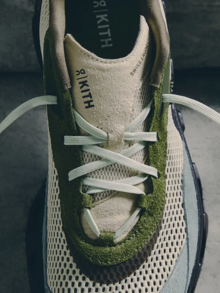 Close-up of a green and white sneaker with white laces, mesh panels, and “HIKIT” and “SWISS ENGINEERING” text