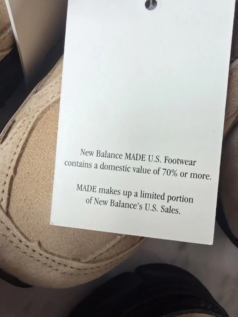 Tag on a tan New Balance shoe stating it is made in the U.S. with 70% or more domestic value