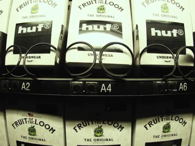 Black-framed glasses displayed on shelves in front of Fruit of the Loom HUF underwear packages labeled A2, A4 and A6