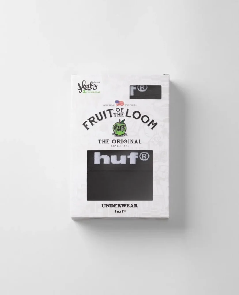 White Fruit of the Loom and HUF underwear package on a white surface, with black logo panels and printed branding