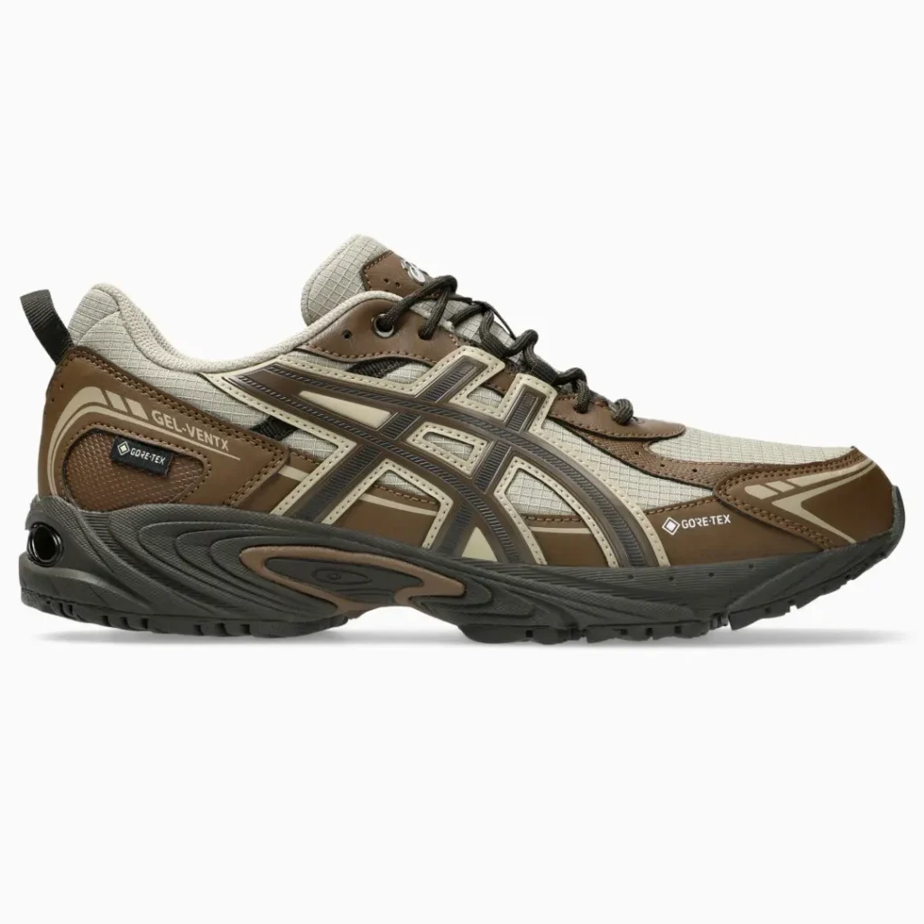 Side view of a brown and beige ASICS GEL-Venture sneaker with black laces, Gore-Tex panels and rugged black sole on white
