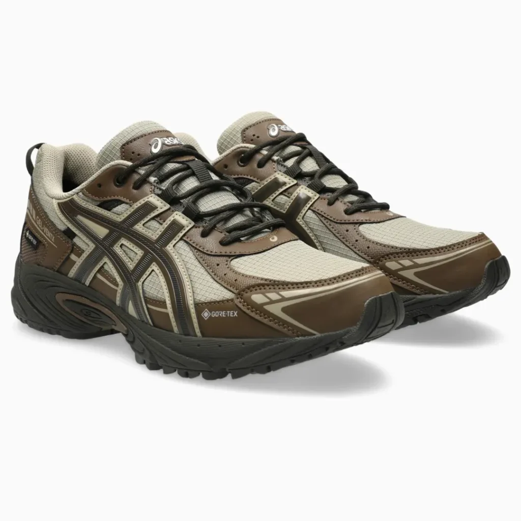Pair of brown and beige ASICS GEL-KINETIC GTX trail sneakers with black laces on a white background