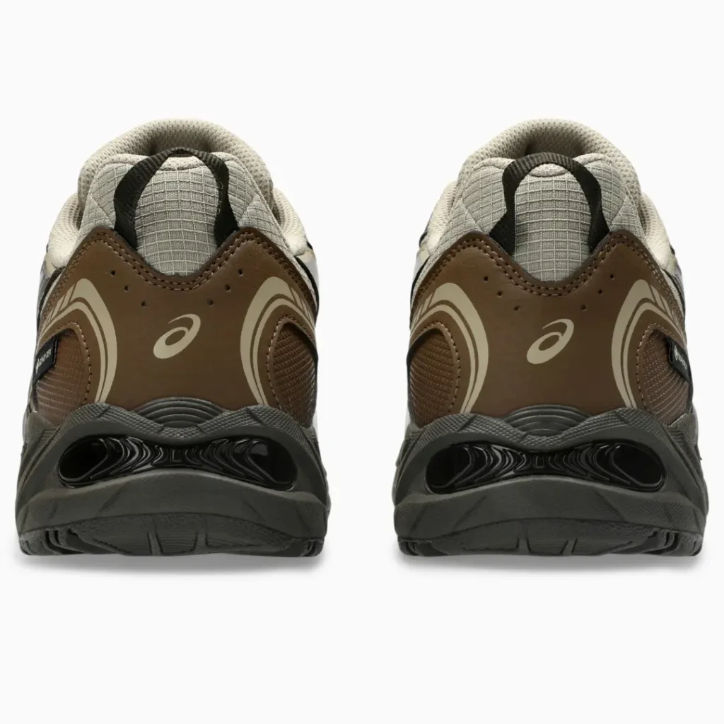 Pair of brown and gray Asics sneakers shown from the rear against a white background