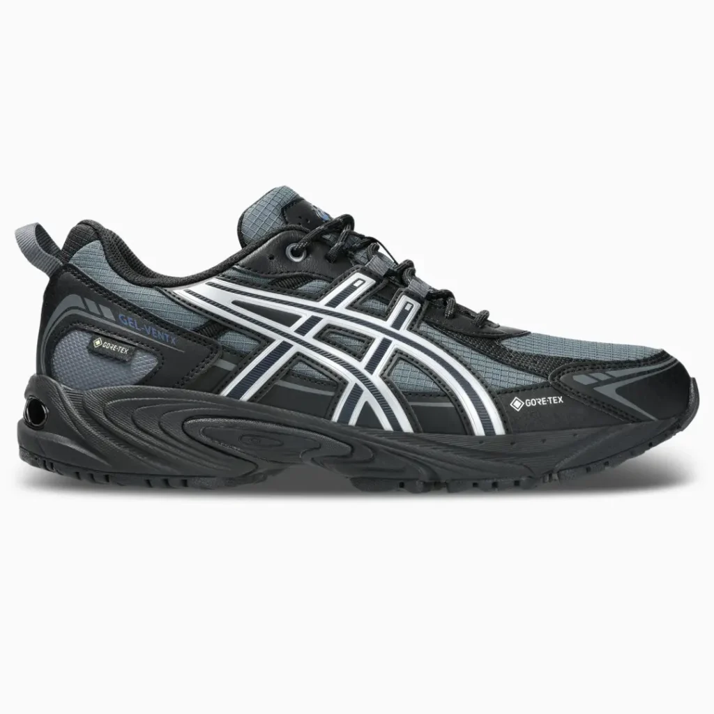 Black and gray ASICS trail shoe with white stripes and Gore-Tex markings, shown in side profile on a white background
