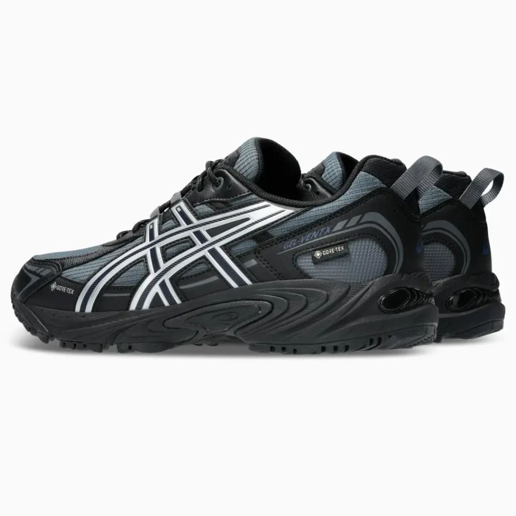 Pair of black ASICS GEL-Venture Gore-Tex sneakers with white stripes, shown against a white background