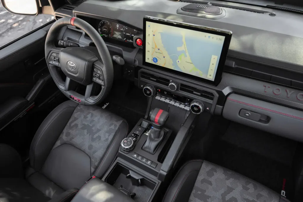 Toyota Tacoma TRD Pro front cabin with black seats, steering wheel, dashboard, touchscreen navigation, and center console