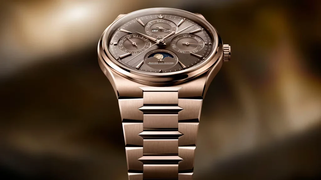 Close-up of a rose-gold Jaeger-LeCoultre watch with a brown dial, multiple calendar subdials, and integrated bracelet on a